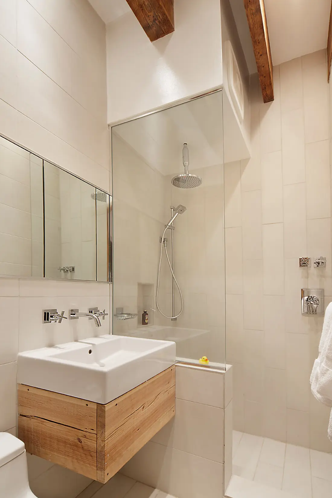 Bathroom in the Crane Residence with a reclaimed wood vanity, vessel sink and walk-in glass shower under exposed beams