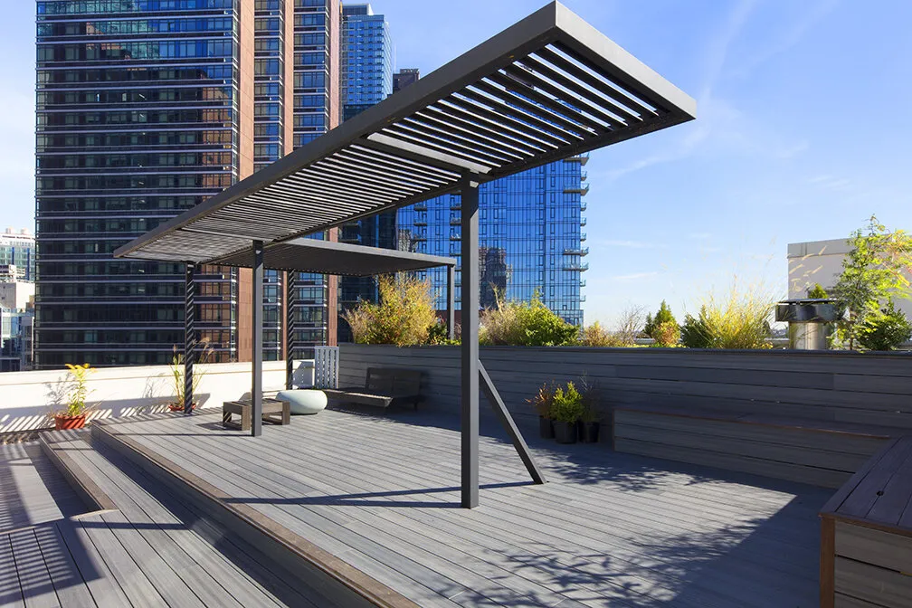 Custom steel pergola on a rooftop deck on Thompson Avenue with the Long Island City skyline behind it
