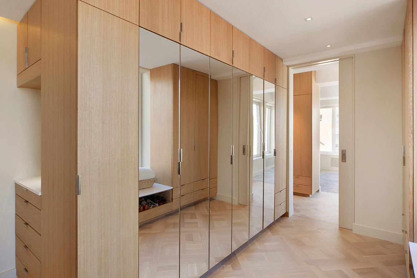 Full-height wood wardrobes with mirrored doors in an Upper East Side apartment in New York