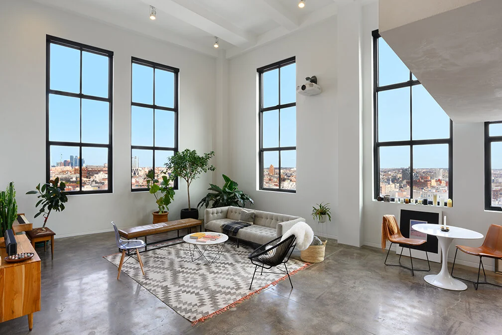 Finished living area with large black-framed windows in Williamsburg, Brooklyn
