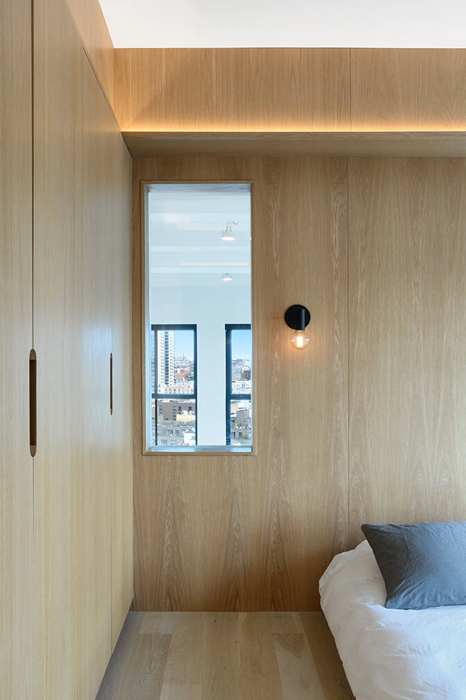 Wood wall panels and bedside millwork in a Williamsburg bedroom