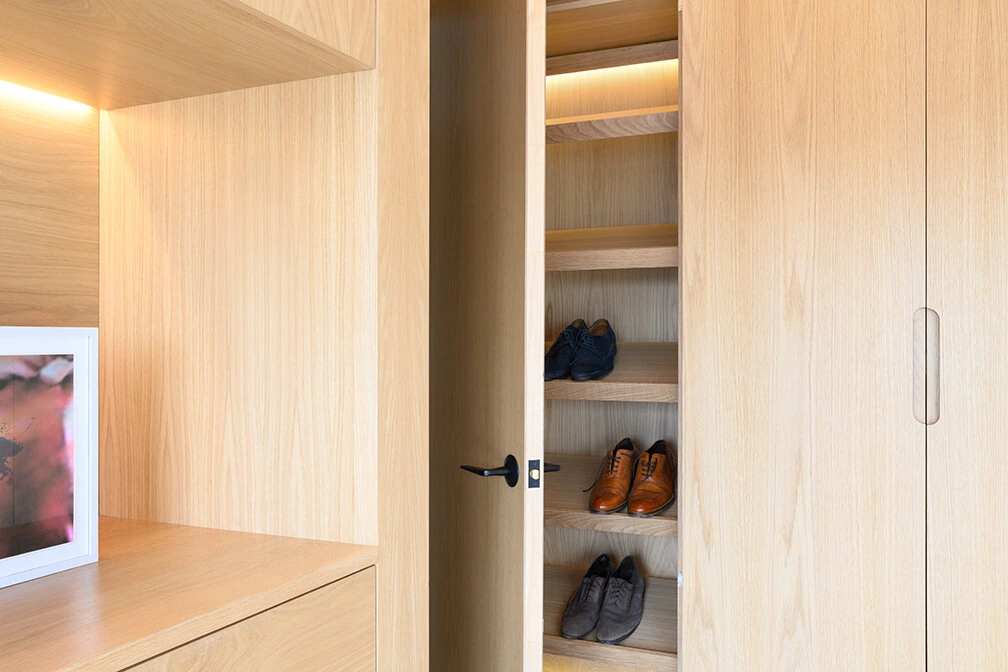 Open closet shelving and wood drawers in a Williamsburg bedroom