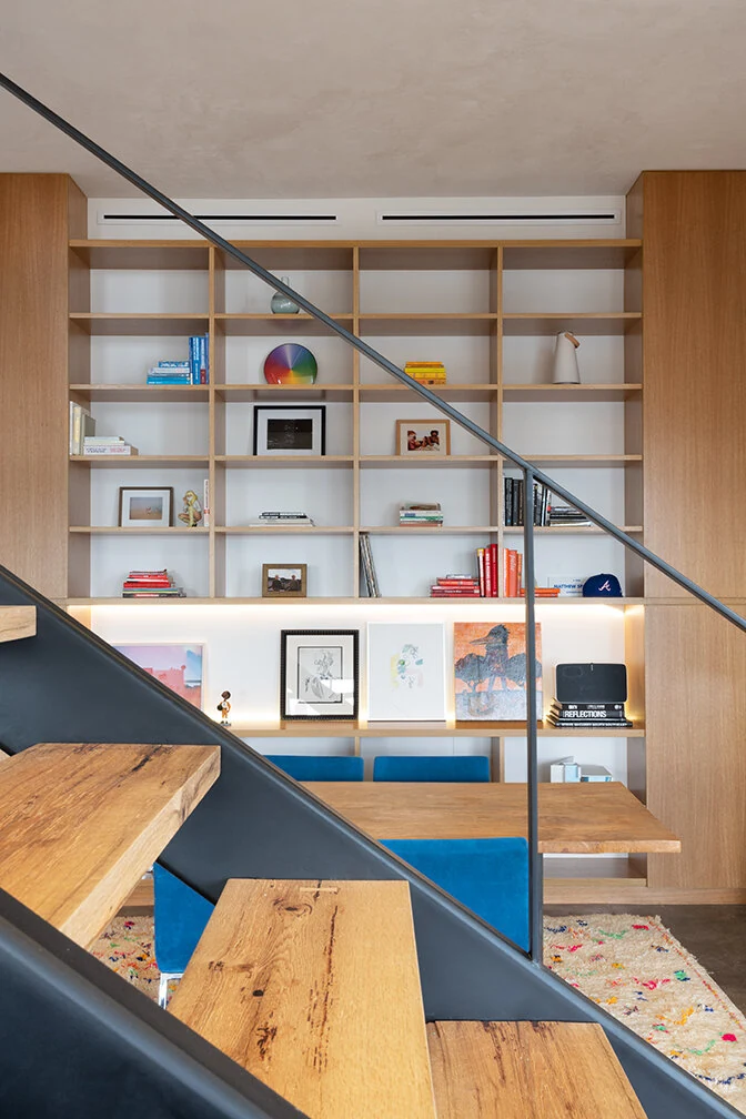 Built-in display shelving beside the loft staircase in Williamsburg