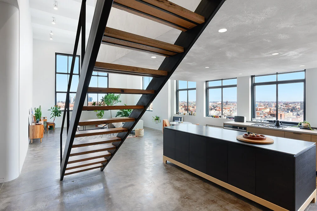 Double-height Williamsburg loft with an open stair and kitchen island