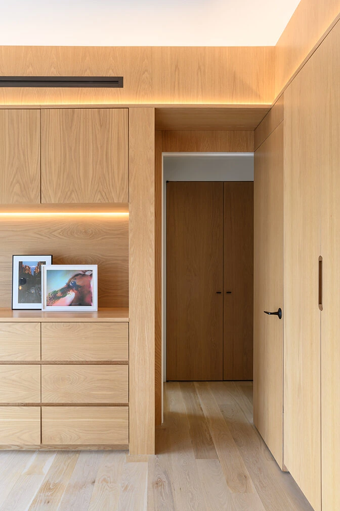 Wood bedroom cabinets and a tall wardrobe opening in Williamsburg