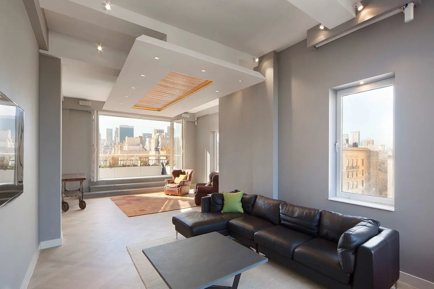 Upper East Side living room in New York with tall windows, gray walls and an illuminated slatted ceiling feature